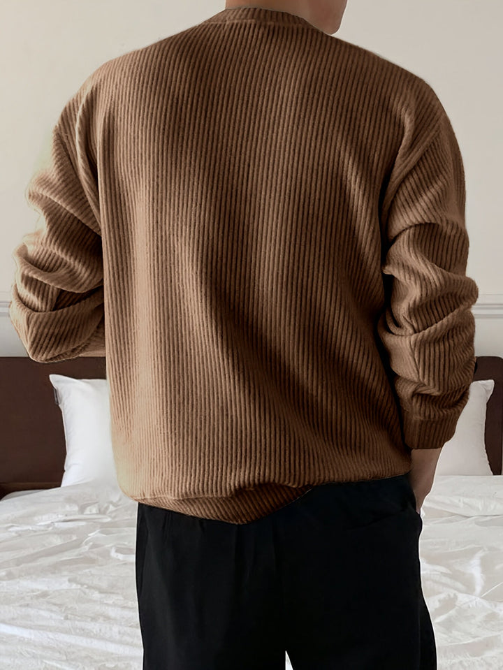 Herre pullover med løs pasform i ribstrik. Rund hals for en moderne, afslappet og klassisk stil.