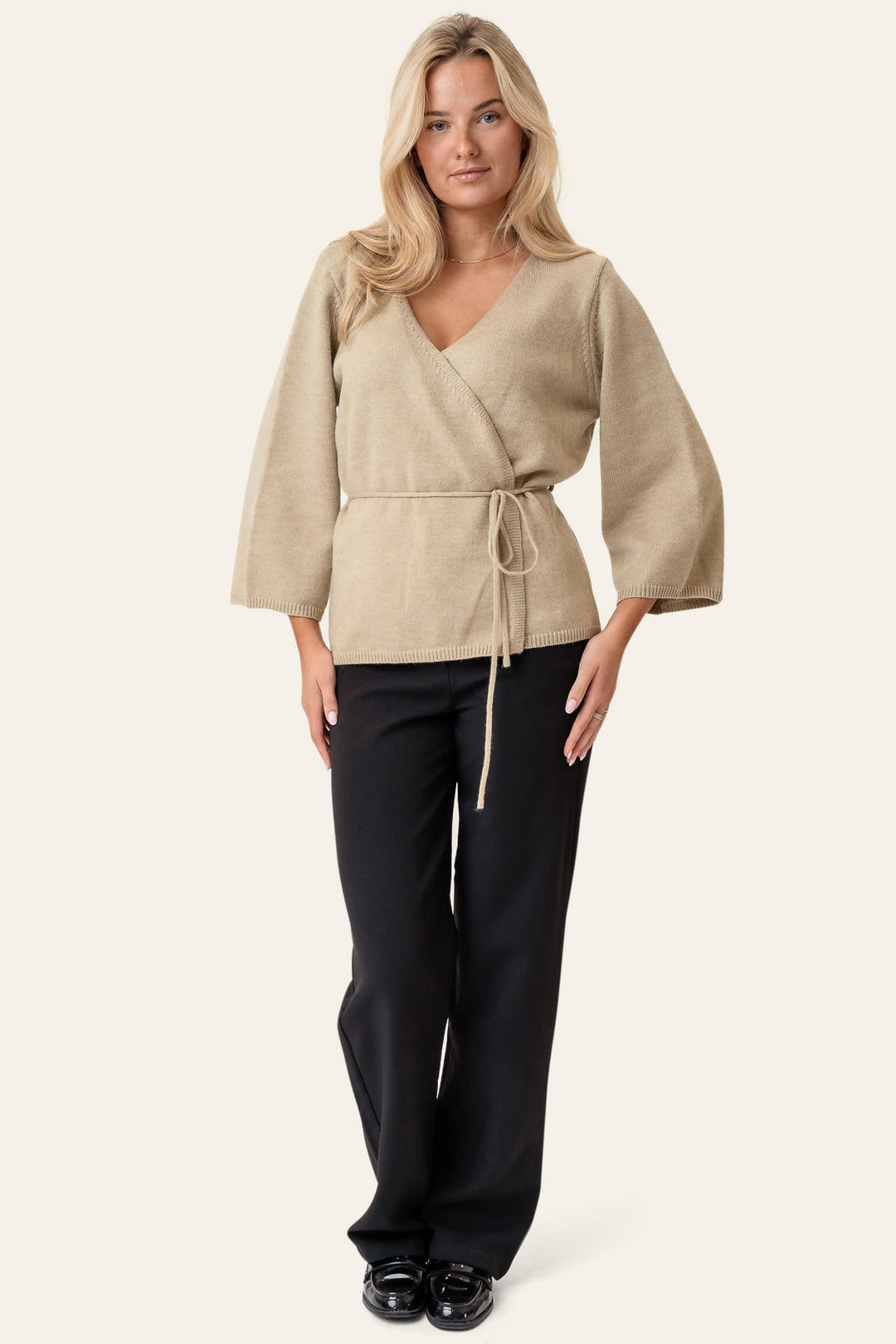 Kvinders elegante beige slå-om cardigan med bælte. En tidløs trøje til enhver garderobe.