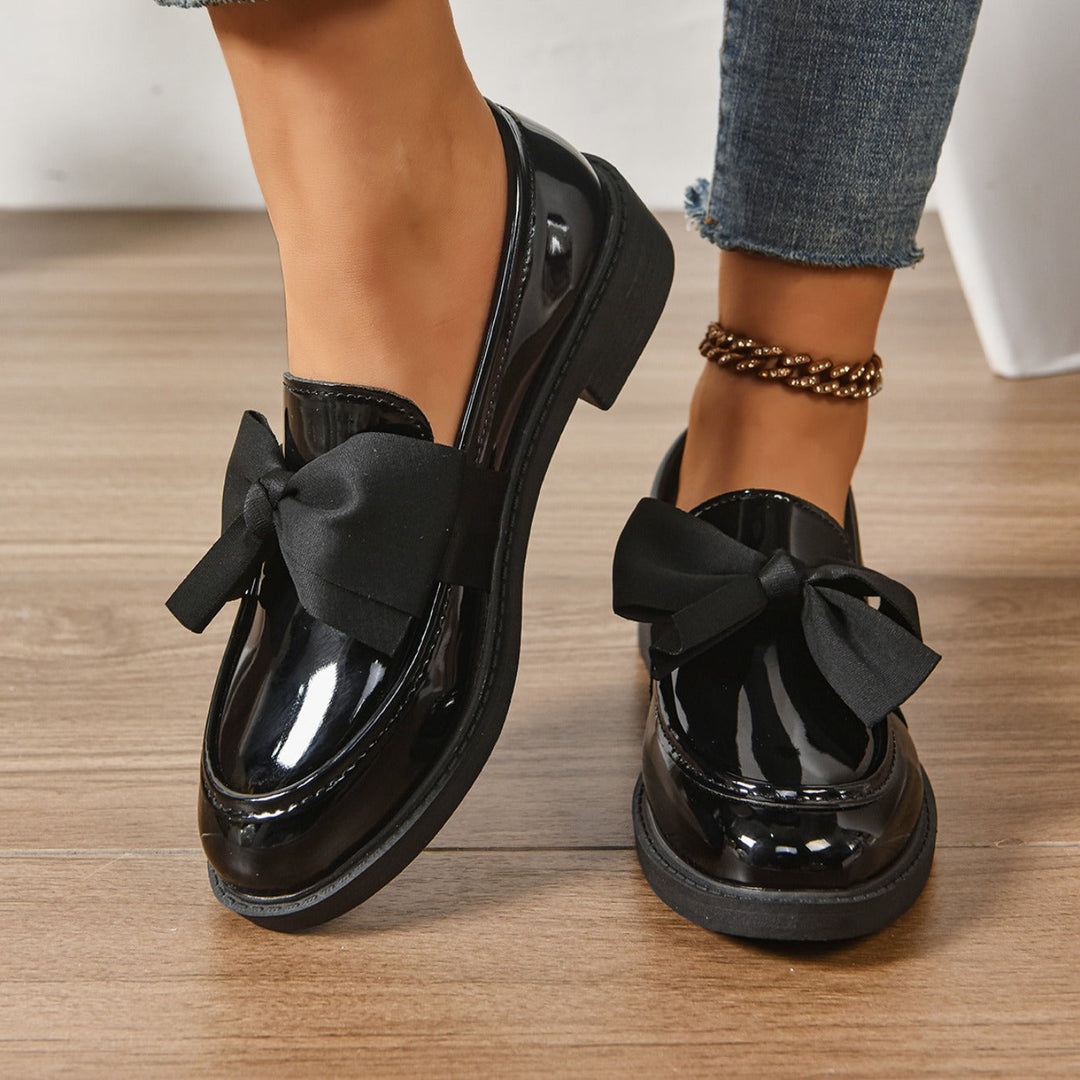 Grønne dame loafers set ovenfra, fremhæver sløjfe & komfortabel stil. Stilfulde slip-on sko.