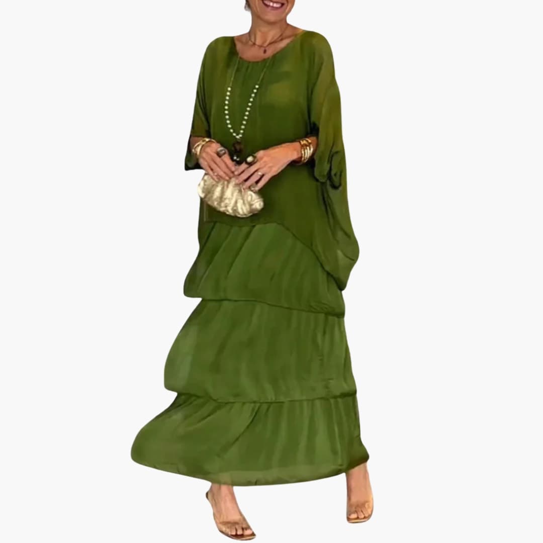 Elegant kvinders maxi kjole med smock ærmer, A-line snit og rund hals. Perfekt som sommer- eller hverdagskjole.