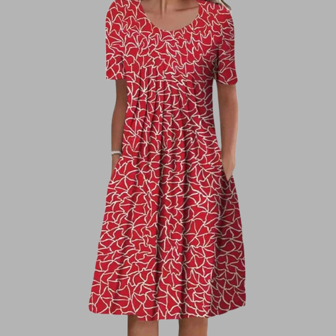Alsidig kvindekjole med blomsterprint, behagelig pasform og plads til det essentielle.