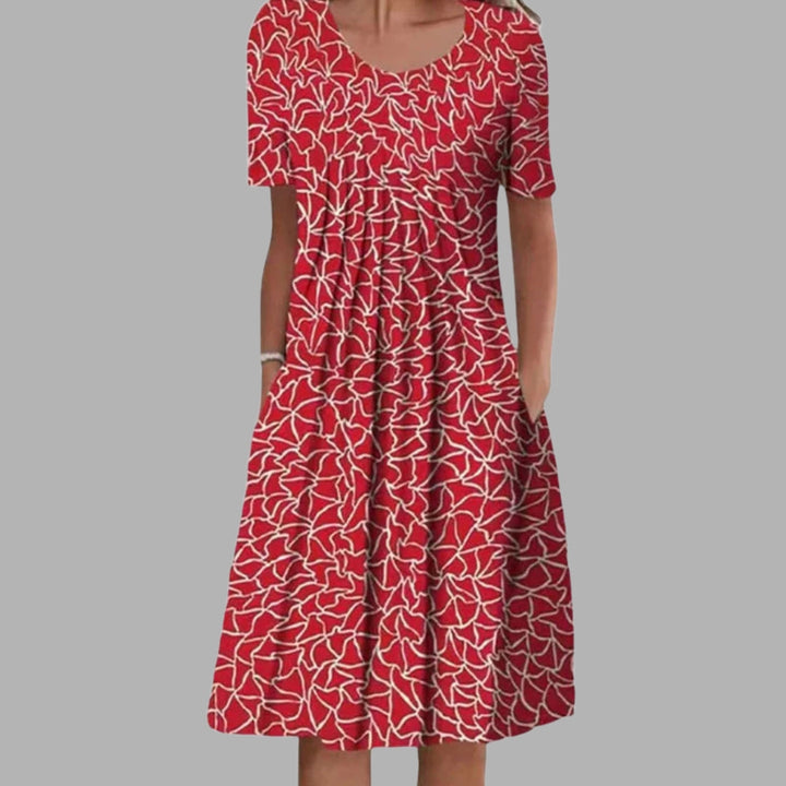 Alsidig kvindekjole med blomsterprint, behagelig pasform og plads til det essentielle.