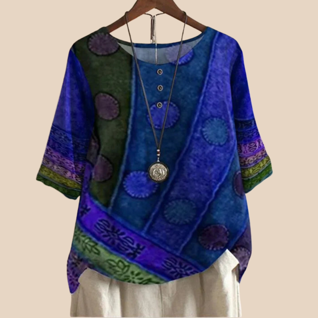 Elegant kvindebluse med unikt, farverigt kunstnerisk tryk. Alsidig top til både hverdag og fest i sommer/forår.