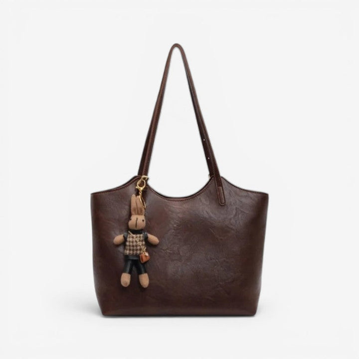 Mørkebrun dametaske med organiseret indre, sikker lukning og justerbar strop. Praktisk og stilfuld.