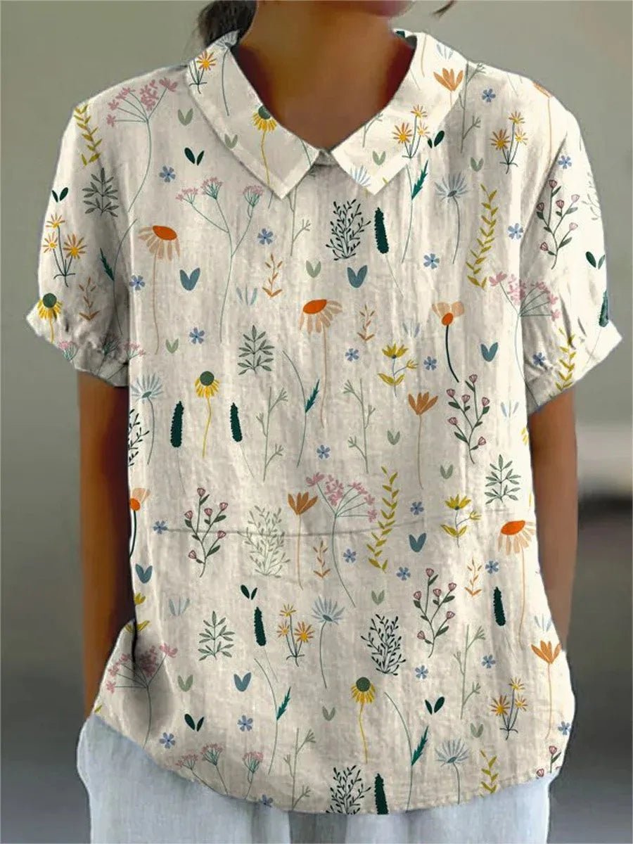 Dame polo skjorte med elegant blomstermønster, løs pasform og klassisk krave, perfekt til forår og sommer.