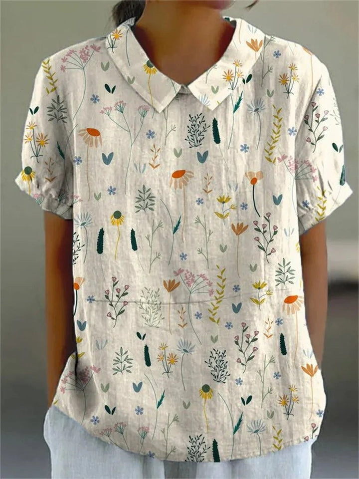 Dame polo skjorte med elegant blomstermønster, løs pasform og klassisk krave, perfekt til forår og sommer.