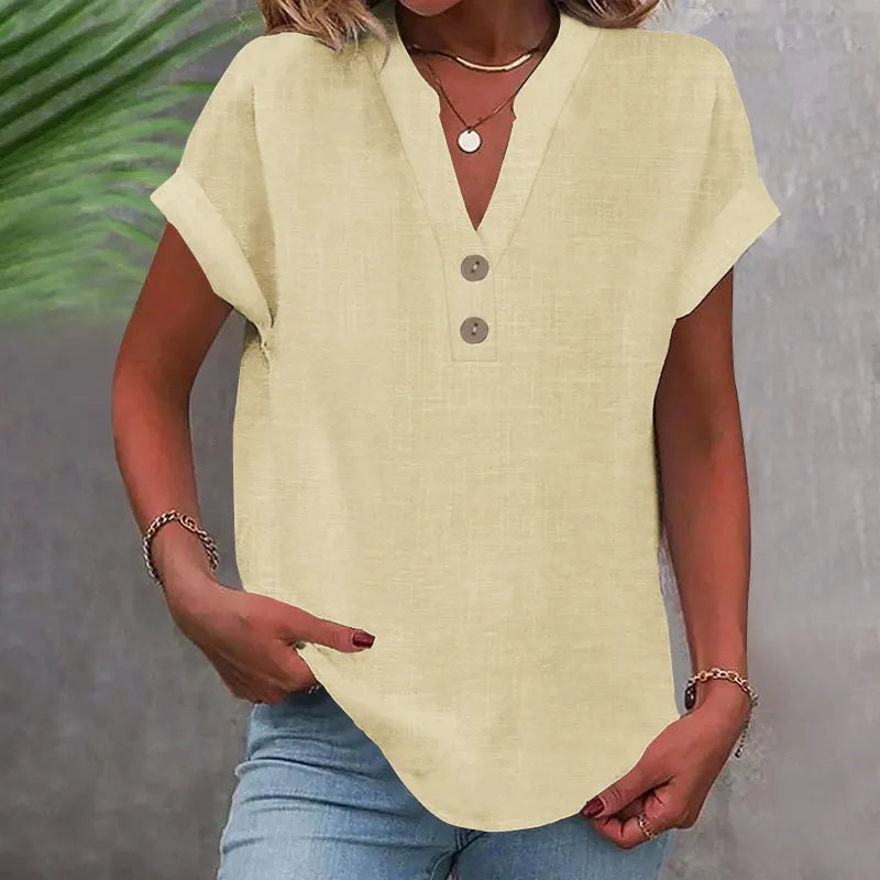 Damebluse med V-udskæring, knapper og løs pasform. Perfekt som sommerbluse til hverdag.