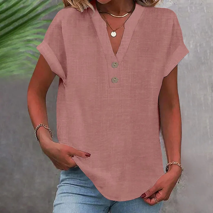 Elegant damebluse med V-udskæring, knapper og en flatterende løs pasform. Perfekt som sommer tøj.