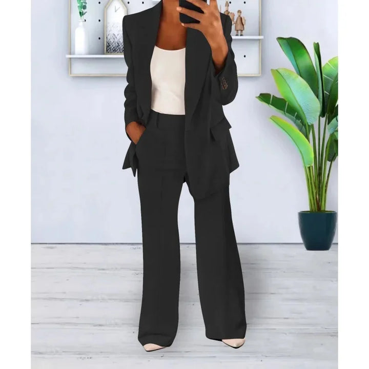 Chic damesæt med lang blazer og elegante vide bukser til fest eller professionelle events.
