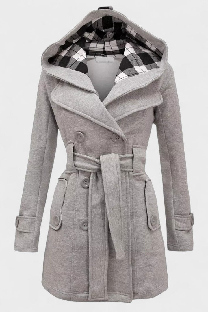 Stilfuld dobbeltradet kvindefrakke. Varmt uld overtøj med elegant design til vinter.