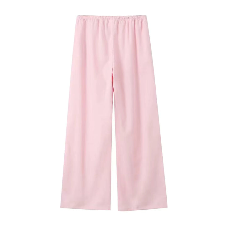 Kvinde pantsuit i elegant, løs pasform med vide ben. Komfortabelt sæt, perfekt til både arbejde og fest.