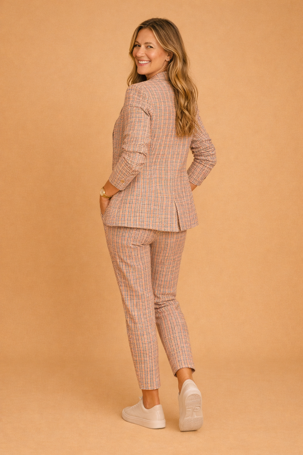 Stilfuldt todelt dame sæt: Lyserød/grå ternet smart-casual jakke og matchende bukser. Komfortabelt og elegant mode-statement.