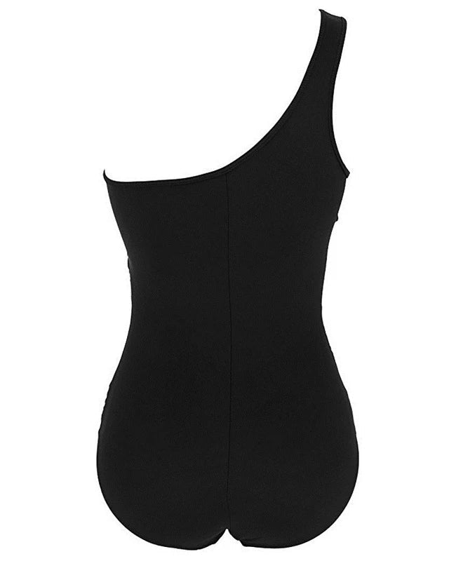 Kvindebadedragt i sort med asymmetrisk mesh. Shaping og push-up for et selvsikkert look. Komfortabel bademode til aktiv sommer.