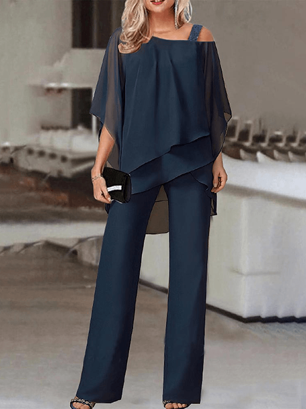 Elegant todelt sæt til kvinder med asymmetrisk top og vide bukser. Perfekt til fest & aftenlook.