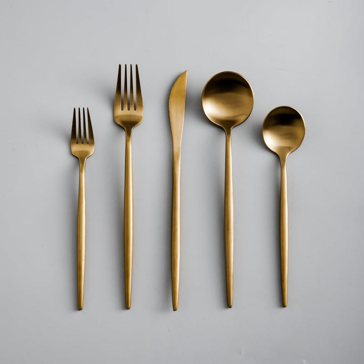 Elegant minimalistisk bestiksæt i rustfrit stål, guldfarvet, med rene linjer til stilfuld borddækning; 20 dele.