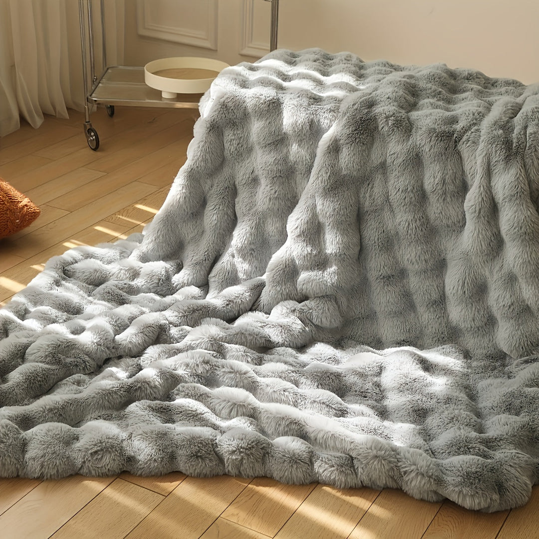 Varmt og blødt vintertæppe i faux fur. Essentielt til kolde dage, skaber komfort og stil.