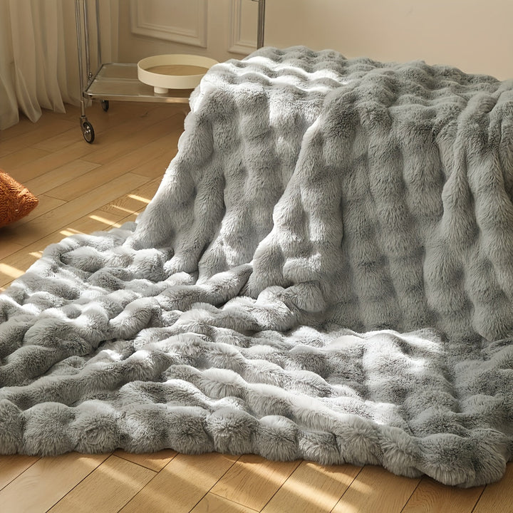 Varmt og blødt vintertæppe i faux fur. Essentielt til kolde dage, skaber komfort og stil.