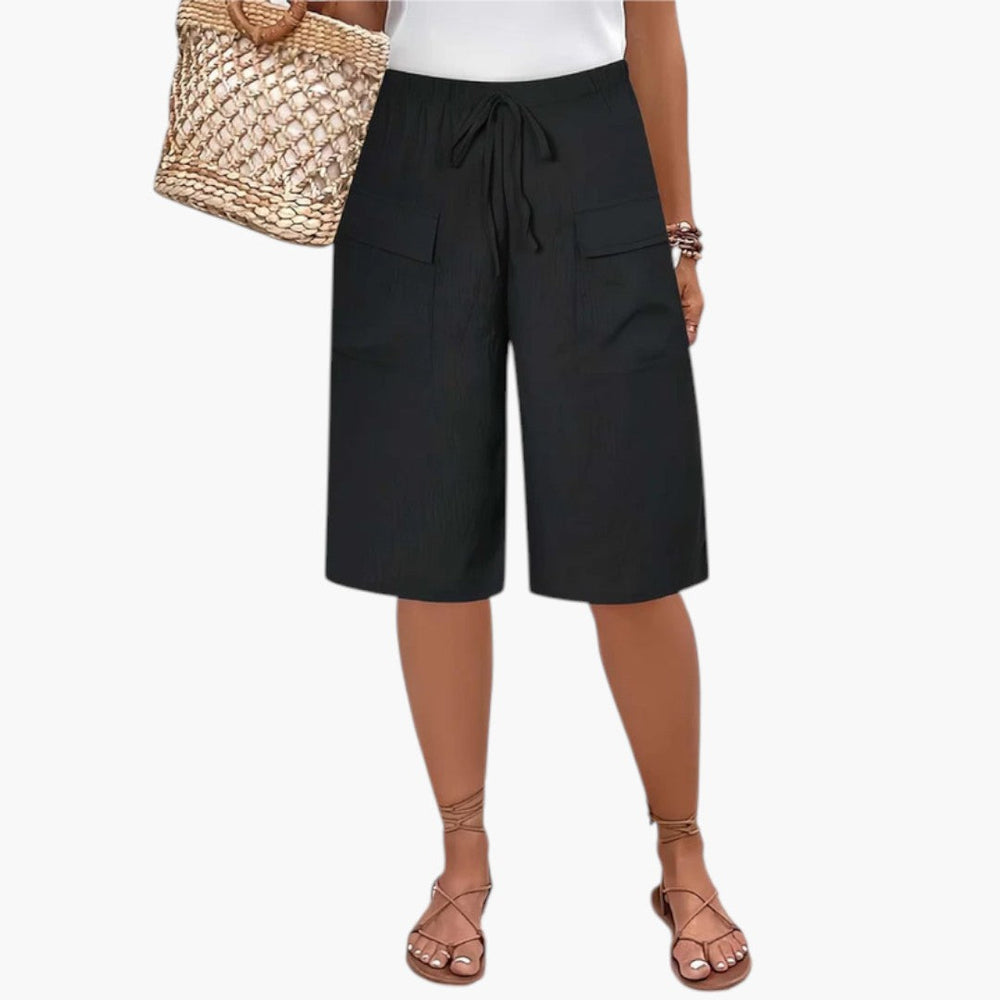 Afslappede sorte kvinders shorts med elastisk talje, justerbar snor, komfortable til strand og casual brug.