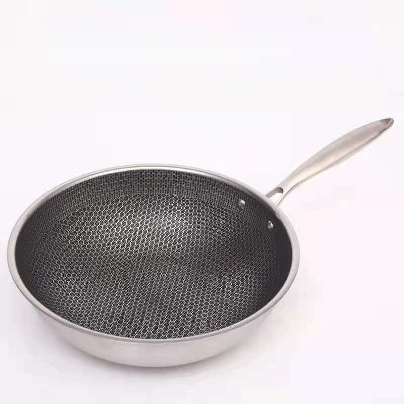 Ridsefast stegepande i rustfrit stål med non-stick belægning, ergonomisk håndtag og vaffelstruktur for jævn varmefordeling.