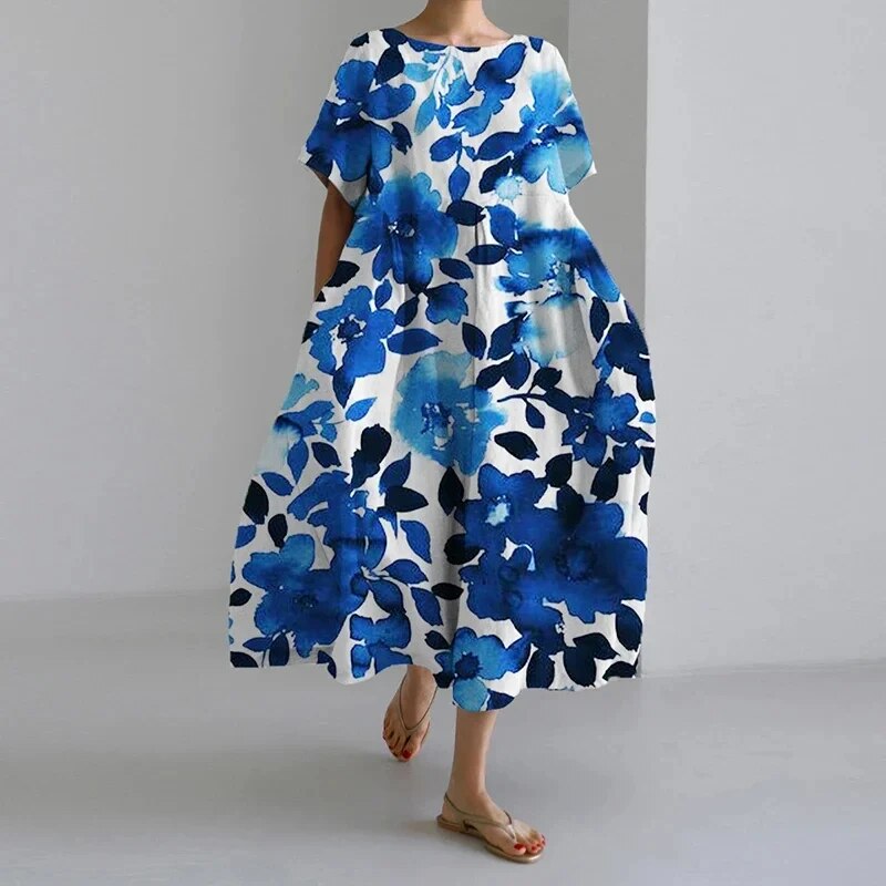 Boho-inspireret lang kjole med farverige blomster, perfekt til den feminine og afslappede sommerstil.