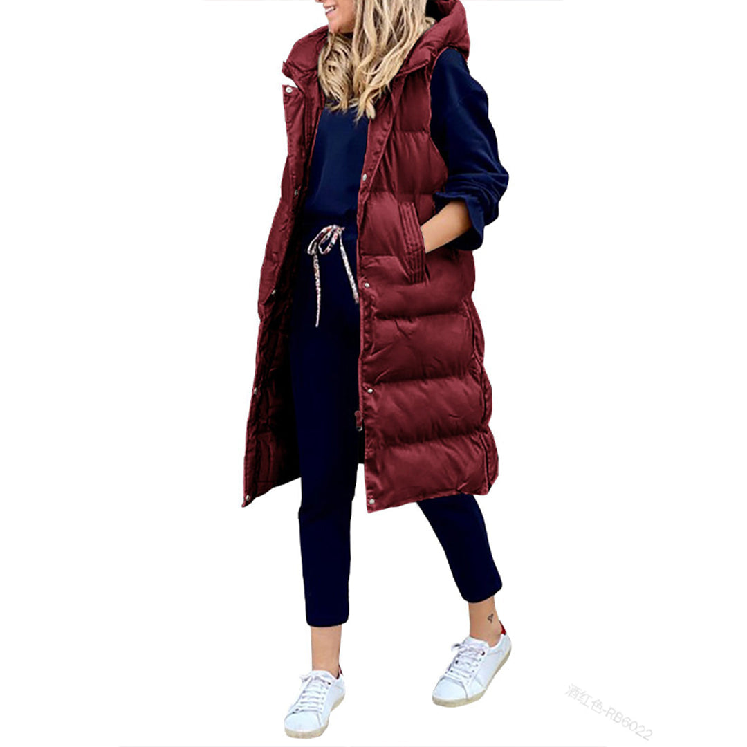 Komfortabel lang puffer hættevest til kvinder. Essential overtøj.