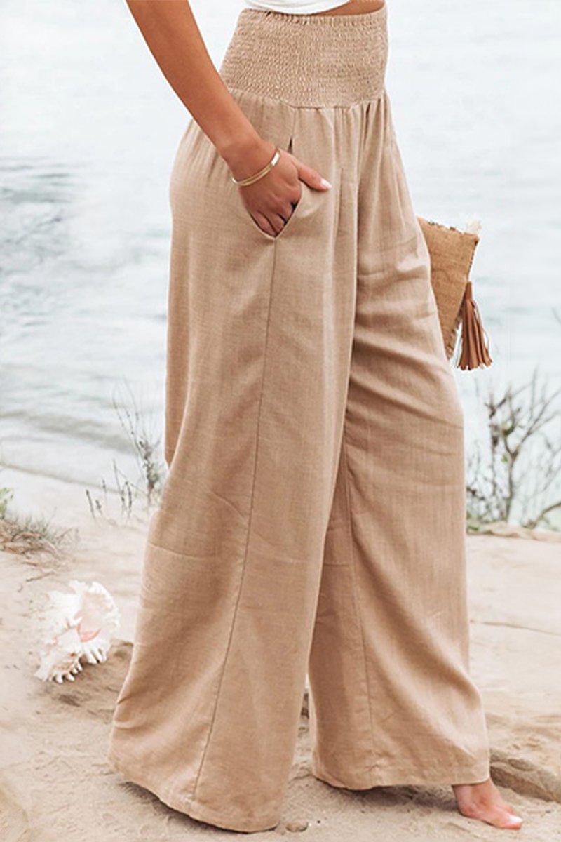 Komfortable højtaljede hør bukser med smock talje og wide leg pasform. Ideel til sommer og fritid.