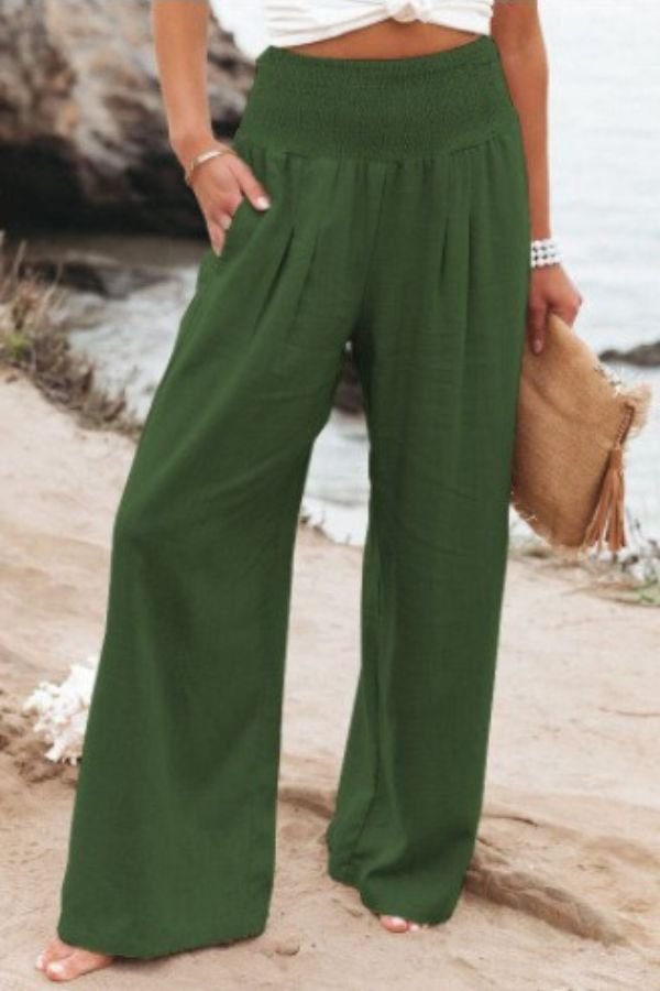 Højtaljede wide leg hør bukser til damer med elastisk smock talje. Perfekte til strand og sommerstil.