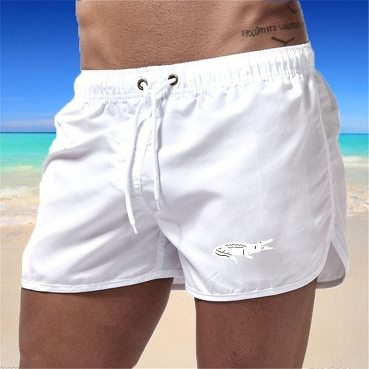 Flerfarvede, lette strandshorts med elastisk talje og moderne print, perfekt til sommer og sport.