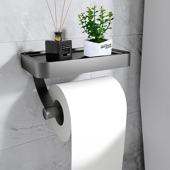 Grå metal toiletpapirholder med robust hylde, moderne og praktisk til ethvert badeværelse.