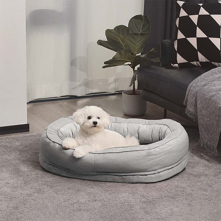 Ortopædisk fluffy kæledyrsseng i donutform, beige, til hunde, tilbyder komfort og støtte på glatte gulve.