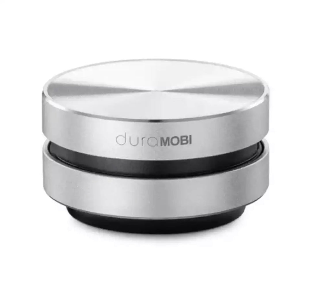 Sølv bærbar vibrationshøjttaler omdanner enhver overflade til trådløs lyd. Kompakt Bluetooth rejsehøjttaler.