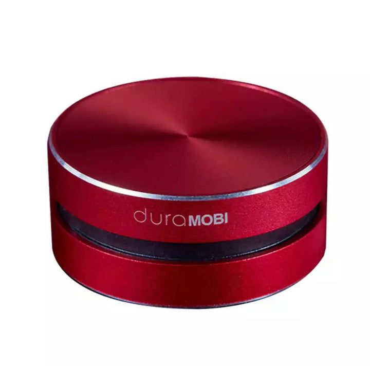 Kompakt rød trådløs vibrationshøjttaler. Gør borde til højttalere med Bluetooth. Perfekt til rejser og musikstreaming.