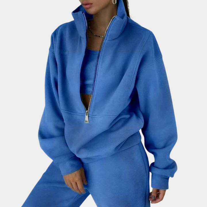 Trendy overdimensioneret dame joggingsæt med halv lynlås. Perfekt til athleisure og stilfuld hverdagsmode.