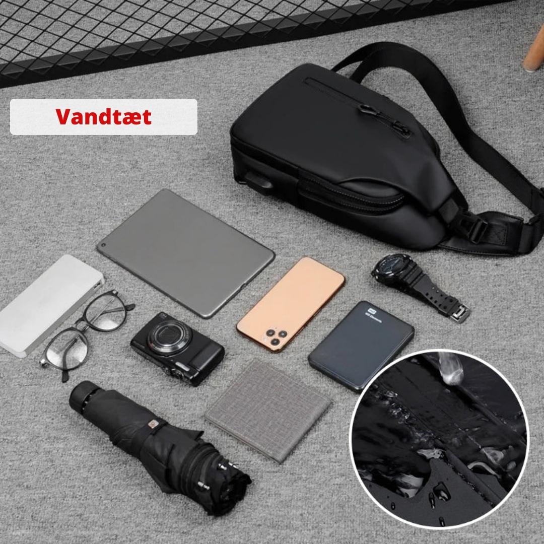 Sikker rejsetaske med flere rum og integreret USB-oplader til mobil.