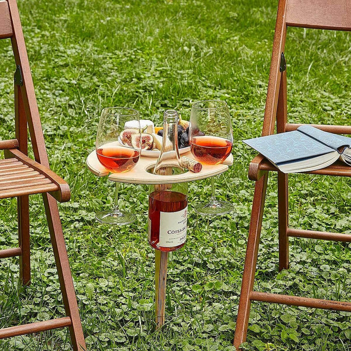 Variabelt trævinbord, ideelt til picnics, med plads til vinflaske, 2 glas og tallerkener i haven.