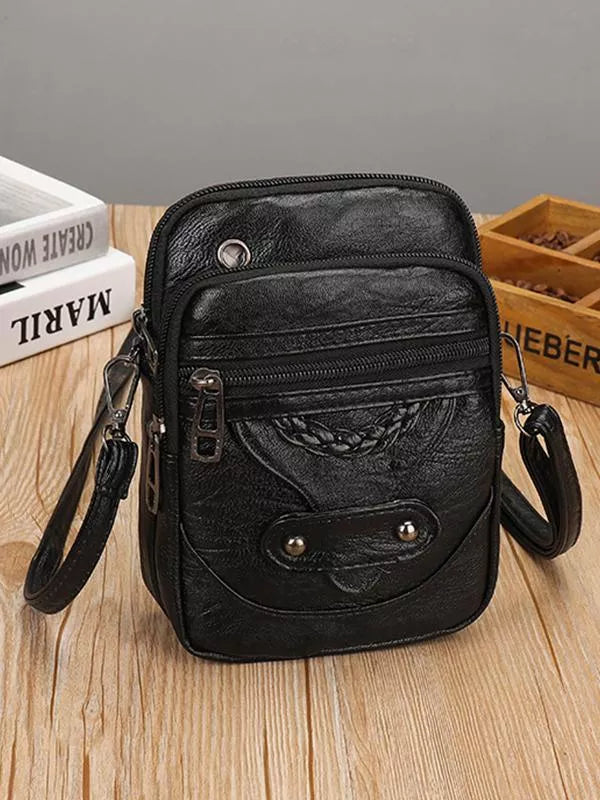 Stilfuld sort vintage crossbody-taske i PU-læder. En elegant og praktisk skuldertaske til kvinder.